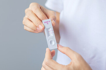 man holding Rapid Antigen Test kit with Negative result during swab COVID-19 testing. Coronavirus Self nasal or Home test, Lockdown and Home Isolation concept