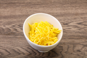 Shredded yellow cheese in the bowl