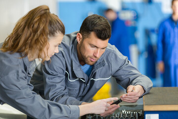 woman and man mechanic working together