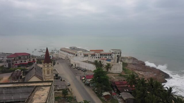 Aerial Cape Coast Castle ocean coastal road part 2 Ghana. Cape Coast Castle is one of forty slave castles, or forts, built on the Gold Coast of West Africa, now Ghana by European traders.
