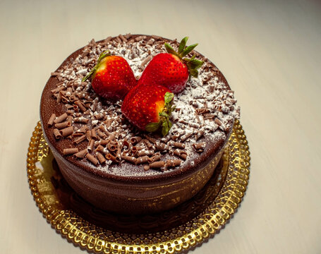 Black Forest Chocolate Cake With Strawberries On Top And Chocolate Chips, White Background.