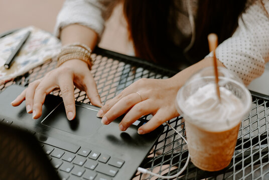 Closeup Shot Of A South Asian Young Woman Working With The Computer In The Cafe