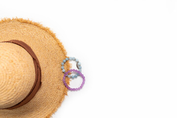 Marine women's bracelets made of natural stone. Straw hat. White background.