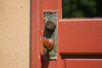 old and antique door with red door handle