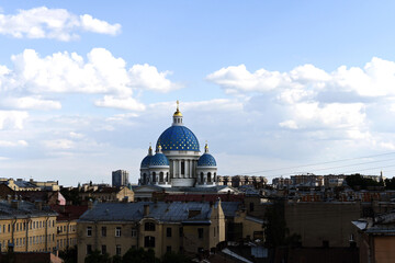 Fototapeta na wymiar The Trinity-Izmailovsky Cathedral is an Orthodox cathedral in the central part of the old city against the background of a blue sky with white clouds. 