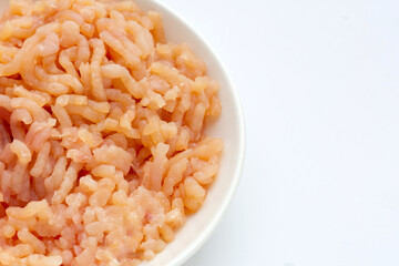 Minced meat of chicken fillet in white plate on white background.
