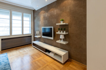 Living room interior, tv mounted on a brown wall