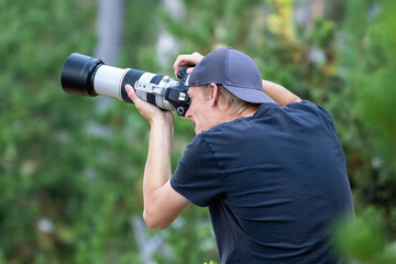 Fototapeta premium Photographer in Yellowstone National Park, Wildlife Photographer, Photographer Telephoto Lens