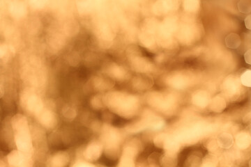 Blurred lights on gold background. Gold beige bokeh background
