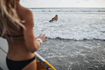 Long haired woman goes surfing