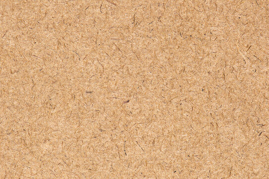 OSB panel, top view. Industrial wall sheet. Plywood brown texture. Cork background. Wood natural grain pattern. Light wood surface. Floor OSB block. Building material board. Loft wall surfaces.