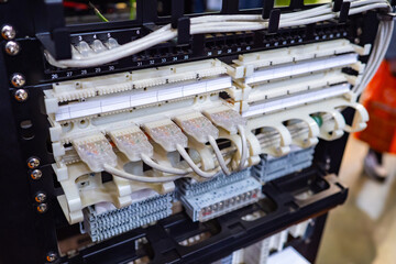 Switchboard close-up. Fragment of electrical panel with many wires. Wire connectors are numbered. Concept - installation of electrical equipment. Distribution of electricity. Electrical switchboard