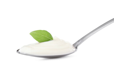 Delicious sour cream with basil in spoon isolated on white