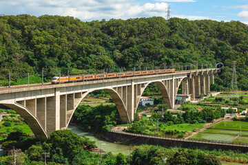 A train cross over liyutan arch bridge in miaoli, taiwan