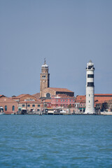 Fototapeta premium Laguna brick buildings and lighthouse of Murano in Venice in Italy.,2019