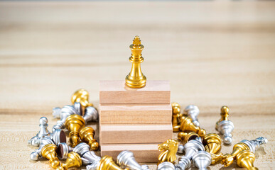 gold queen chess surrounded by a number of fallen silver chess pieces , business strategy