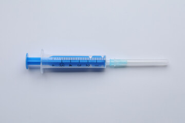 Disposable syringe with needle isolated on white, top view