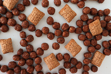 chocolate flakes on a white plate, sweets on a white plate, chocolate pillows on a white plate