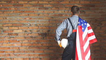 Builder on the brick background . Labor day holiday concept. USA