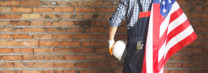 Builder on the brick background . Labor day holiday concept. USA