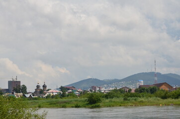 A river with hills and city panorama