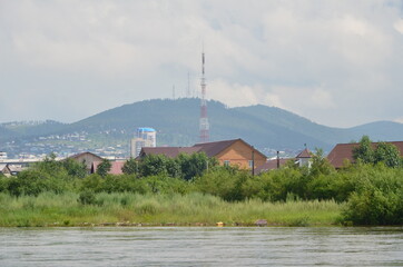 A river with hills and television tower