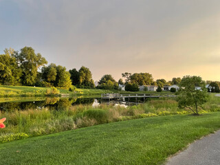 Fototapeta premium Fishing Dock Over a Pond at Sunset