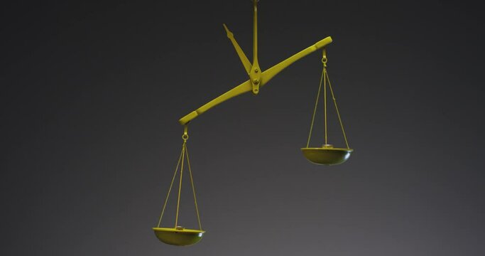 Yellow jewelry retro weigher . The scales are unsteady until they balance . Symbol of justice . Weights on the scales . Studio shot on RED EPIC Cinema Camera with strobe light .