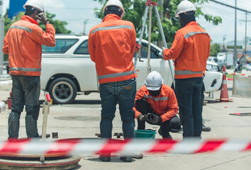 South east asian, people, Technicians clean up oil spill and repairs damaged fuel pump.