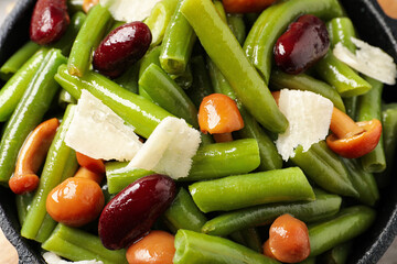 Delicious salad with green beans, mushrooms and cheese, closeup