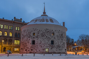 The ancient Round tower close-up in February twilight. Vyborg, Russia