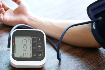 Man check blood pressure monitor and heart rate monitor with digital pressure gauge. Health care and Medical concept