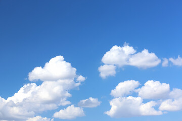 Naklejka na ściany i meble Beautiful white fluffy clouds in blue sky