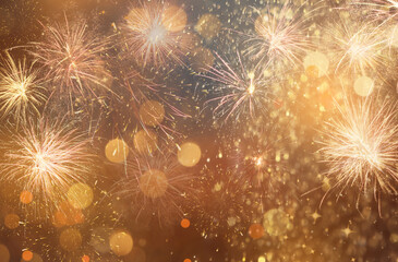 Abstract festive background with fireworks, bokeh effect. New Year celebration