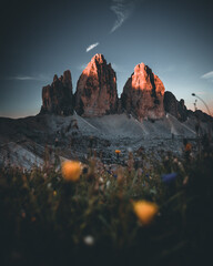 Three peaks of Lavaredo (Drei Zinnen or Tre Cime di Lavaredo) in the Sexten Dolomites National Park during sunrise with light on the peaks