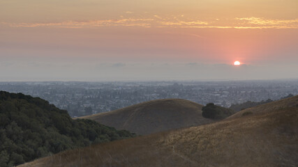 Hazy sunset over Hayward via Hayward Hills in Alameda County, California, USA.