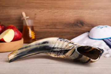 Shofar and other Rosh Hashanah holiday attributes on wooden table