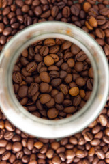 Coffee beans in a transparent jar. The concept of a coffee background or texture.Coffee shop, caffeine. top view. flat lay
