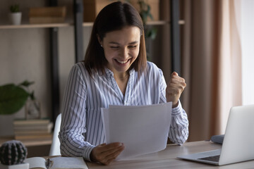 Excited young Caucasian female feel euphoric get pleasant offer or promotion notice in postal...