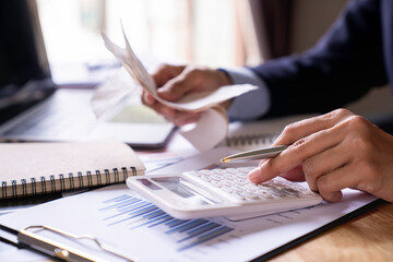 Close-up of a businesswoman using a white calculator, a financial businessman examining the numerical data on a company financial document, Accountant Calculating Electronic Invoice Or E Bill