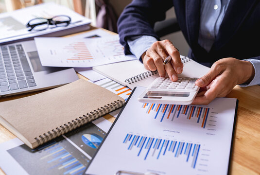 Businessman Accounting Calculating Cost Economic Financial data, taxes, bank account balance and calculating expenses in the living room at home