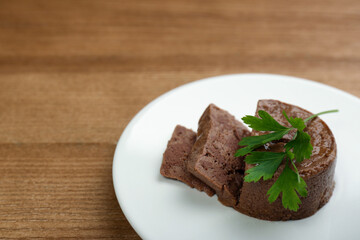 Plate with pate and parsley on wooden table. Pet food - obrazy, fototapety, plakaty