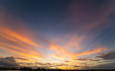 Obraz premium Cumulus sunset clouds with sun setting down. sky with clouds and sun. sweet sky.background and space