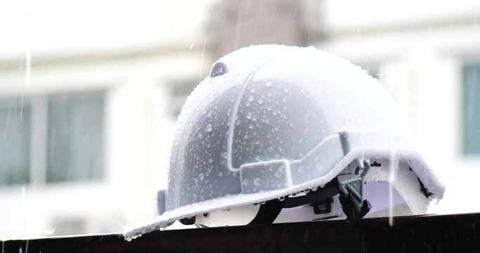 Raindrops on a construction helmet,heavy rain and construction safety helmets, blue hard safety helmet and raining	