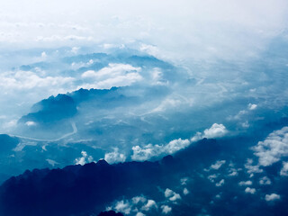 Naklejka premium Blue sky with clouds and mountains seen from above in Vietnam