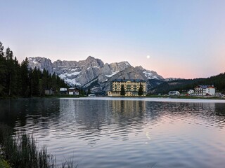 morning mood at lake misurina in the dolomites. morning dawn with the moon over the mountain peaks, tre cime lavaredo