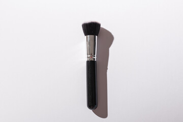 Make-up brush on white background, top view. Cosmetics and beauty concept.