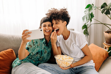 Cheerful couple taking a selfie together at home