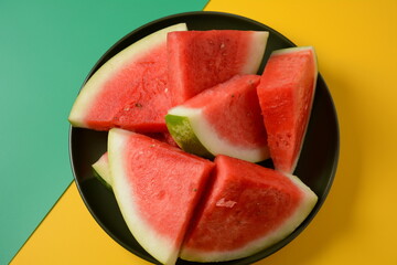 Fresh sliced watermelon pieces on bright background