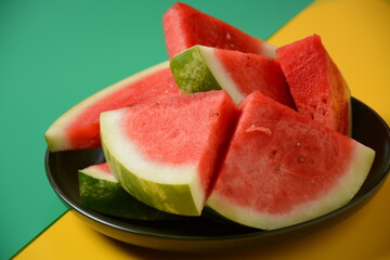 Fresh sliced watermelon pieces on bright background